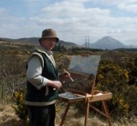 Hamilton Sloan traditional irish artist at his easel outside painting mount Errigal