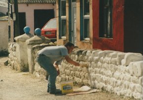 Tory islander whitewashing a wall on tory island
